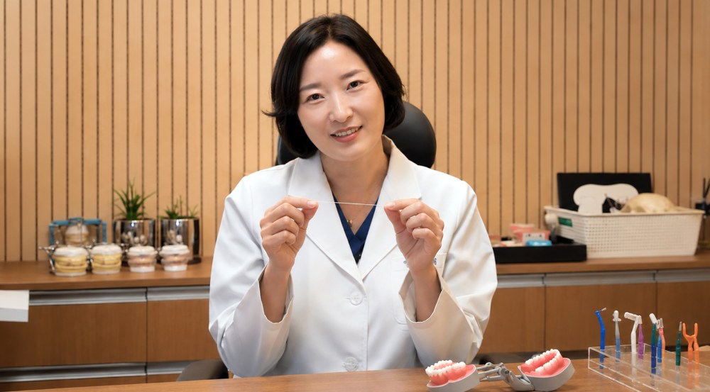 상담실에서 치실 사용법을 설명하는 모습
